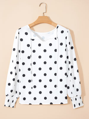 White polka dot blouse with tie neck and smocked cuffs