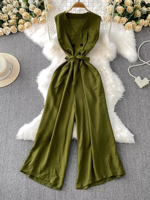 Green V-neck wide leg jumpsuit with tie belt and double button detail.