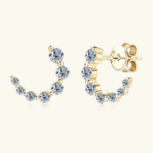 Gold moissanite stud earrings with a celestial arc design and sparkling round-cut stones.