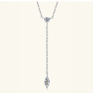 Silver lariat necklace with marquise moissanite pendant and round moissanite accent.