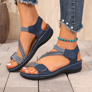 Blue casual adjustable wedge sandals with crisscross straps and ankle strap.