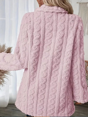 Pink faux shearling coat with cable knit texture and a collared neckline.