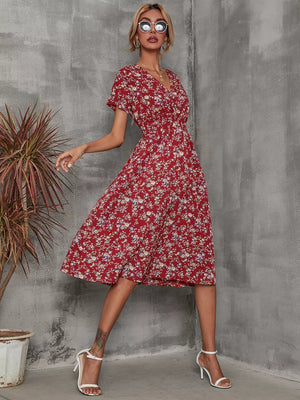 Red floral midi dress with short sleeves, V-neck, and cinched waist.