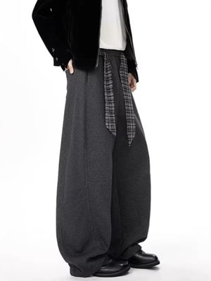 Men's gray relaxed fit wide-leg sweatpants with a plaid tie belt.