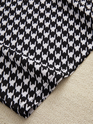 Black houndstooth pencil skirt detail with off-shoulder top fabric texture.