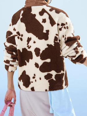 Cow print sherpa button-up jacket with brown accents and a cozy texture.