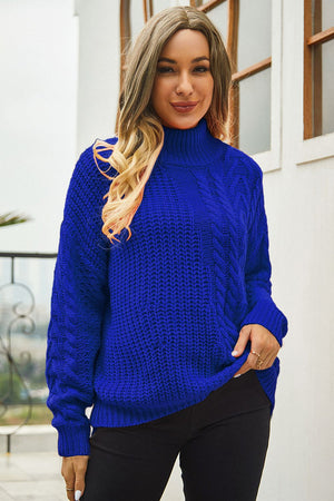 Royal blue acrylic cable-knit turtleneck sweater with voluminous silhouette.