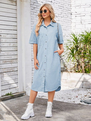 Light blue denim shirtdress with short sleeves, button front, chest pocket, and asymmetric hemline.