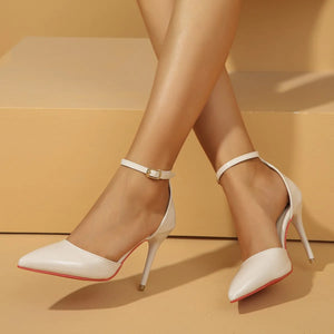 White patent leather ankle strap stiletto pumps with pointed toe and buckle detail.