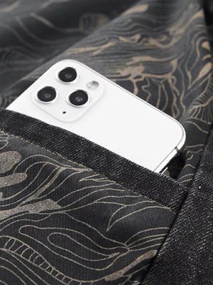 Black denim blazer with a subtle wave pattern lining and a phone in the pocket.