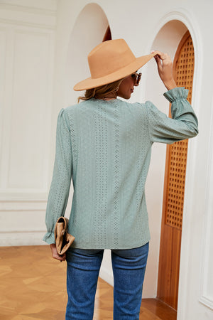 Perforated sleeve blouse in Gum Leaf with ruffle cuffs and lace trim neckline.