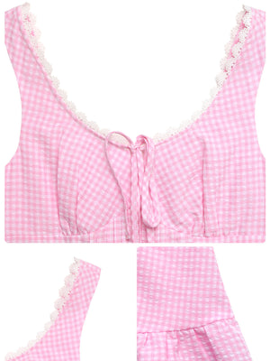 Pink gingham mini dress with sweetheart neckline, lace trim, and tie front.