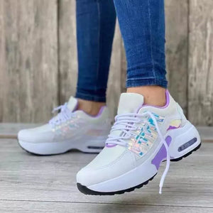 White lace-up chunky platform sneakers with purple accents and iridescent details.