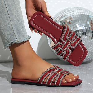 Burgundy open-toe sandals with dazzling rhinestone straps.