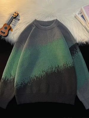 Gradient color block oversized knit sweater with crew neck and chunky knit texture.