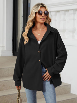 Oversized black corduroy shirt jacket with button front and collar.