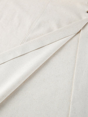 Button front tube maxi dress in beige cotton blend fabric with visible button detail.