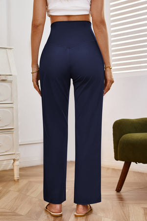 Navy high-waisted flare leg trousers with a v-seam detail, shown from the back.