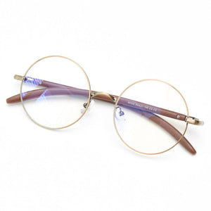 Round frame glasses with clear lenses, gold metal and brown acetate arms, adjustable nose pads.