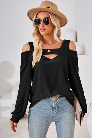Black geometric cutout shoulder top with a v-neck detail and long sleeves.