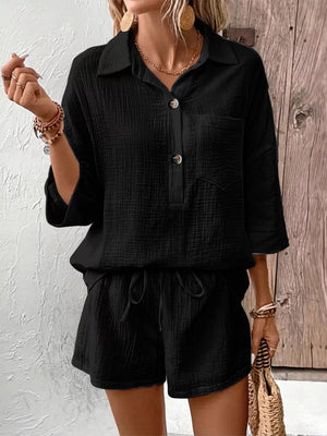 Black cotton two-piece set with buttoned collared shirt and drawstring shorts.