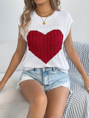 White cable knit sweater vest with a large red cable knit heart graphic.