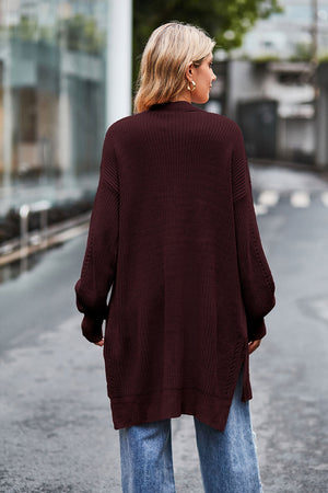 Longline open-knit cardigan in wine with side slits and textured sleeves.
