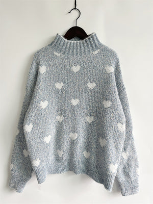 Mint blue acrylic turtleneck sweater with all-over white heart motif.