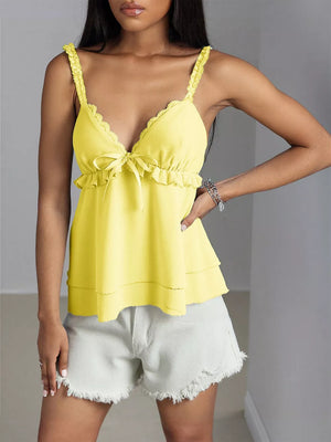Yellow camisole with lace trim, ruffle detail, and bow accent.