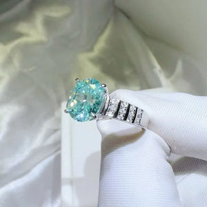 Aquamarine halo oval ring with diamond band.