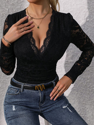 Black lace bodysuit with plunging neckline and long sleeves, styled with jeans.