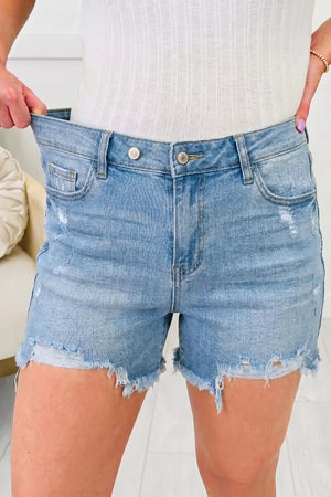 Light wash denim shorts with raw hem and distressed details