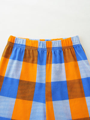 Baby shorts with elastic waistband in blue, orange, and brown plaid pattern.