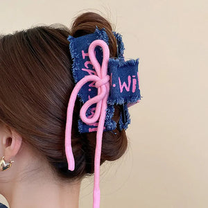 Denim patchwork claw clip with pink drawcord detail.