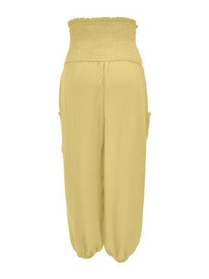 Yellow smocked waist harem pants with pockets and ankle cuffs.