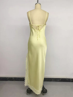 Yellow lace-trimmed midi slip dress with side slit and tie back.