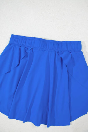 Blue flared skort with elastic waistband and tie detail