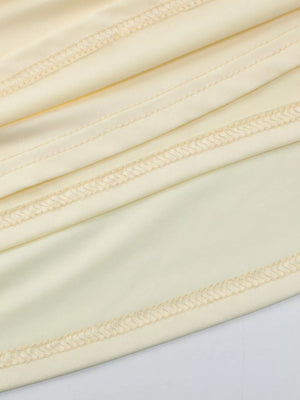 Yellow ruched maxi dress detail with visible stitching
