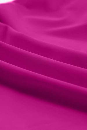 Sculpted tankini with skirted bottom in cerise, showing fabric texture and folds.