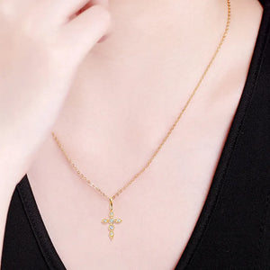 Gold diamond-set cross pendant necklace with delicate chain.
