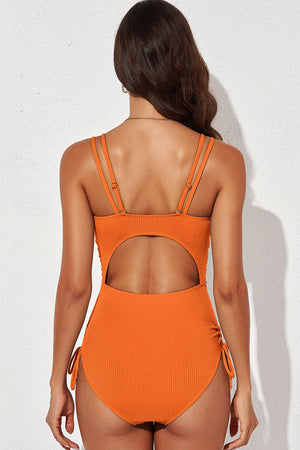 Orange ribbed one-piece swimsuit with cutout back and adjustable tie sides
