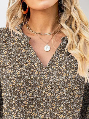 Flutter sleeve floral v-neck blouse in brown with a small yellow and white floral print.