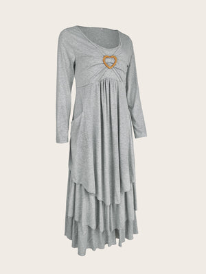 Light gray tiered midi dress with long sleeves, gathered bust, heart detail, and pockets.