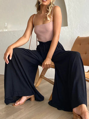 Black wide-leg palazzo pants with gathered waist and drawstring detail.