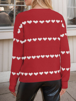Scarlet knit sweater with white heart stripes, crew neck, long sleeves.