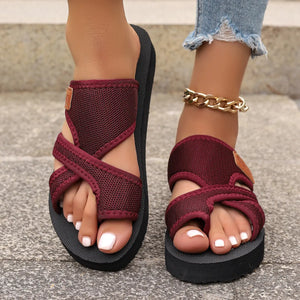 Cross-strap mesh platform slides in deep purple with a toe loop and adjustable strap.