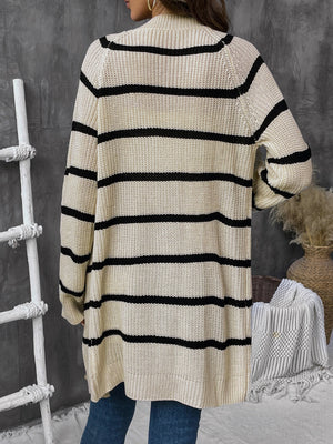 Beige acrylic knit cardigan with wide black stripes and button front.