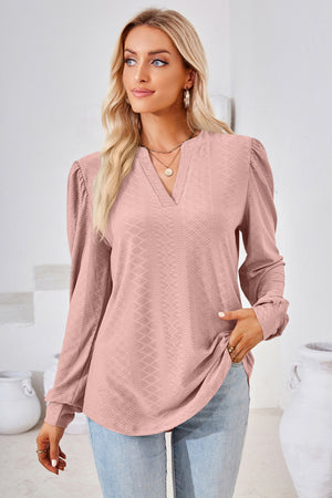 Pink textured bishop sleeve blouse with v-neck and puffed shoulders