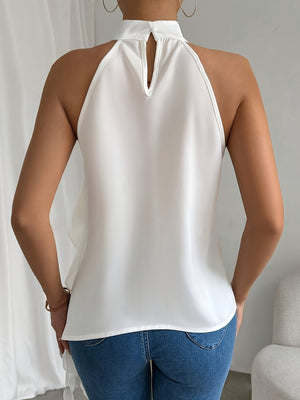 White ruffled halter neck blouse with keyhole detail and flowy back.