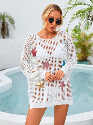White open knit beach cover-up with sequin stars, long sleeves, and crew neck.